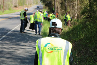 volunteers cleaning up on the side of the road