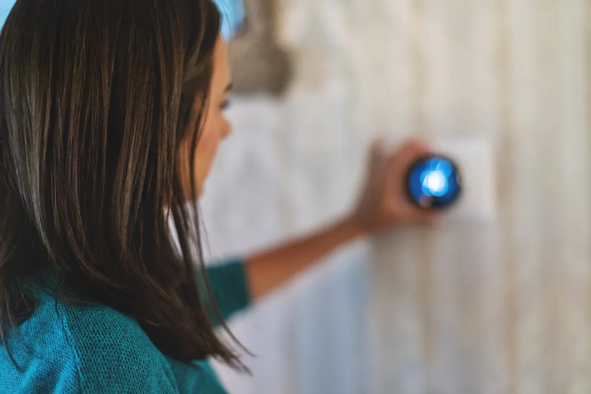 Woman changing the temperature on the thermostat